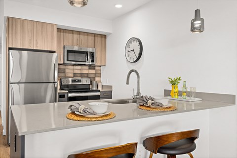 a kitchen with stainless steel appliances and a counter with a sink
