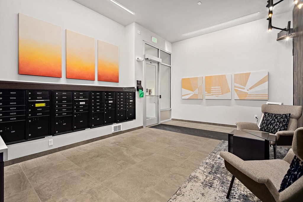 a lobby with chairs and a door to a room with a filing cabinet