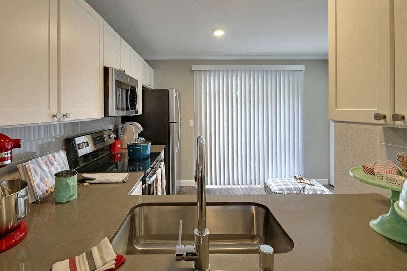 a kitchen with a sink and a microwave