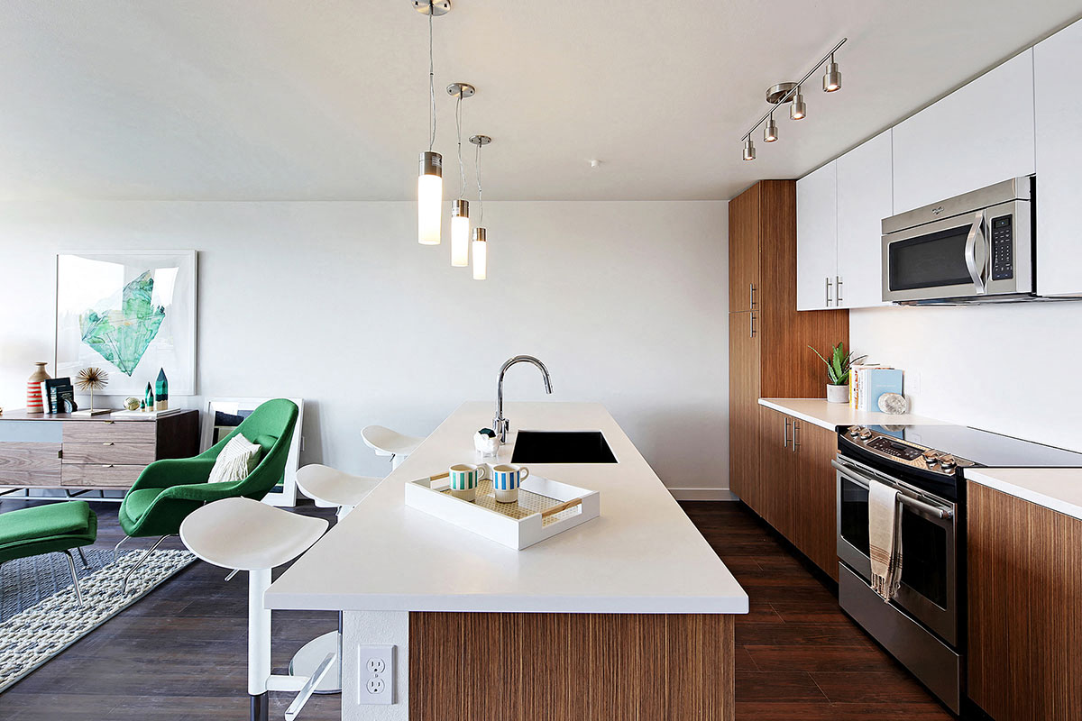 a kitchen and living room with a table and a sink