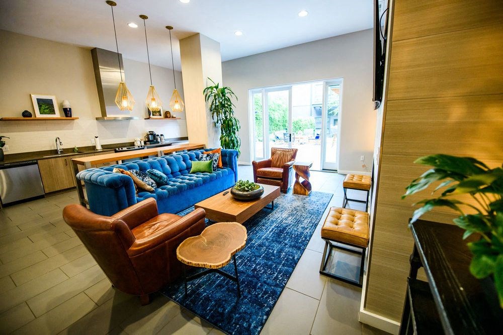 a living room with a blue couch and chairs
