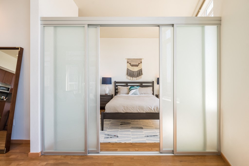 a bedroom with a bed and a window