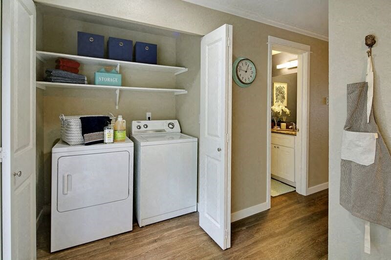 a kitchen with a washer and dryer and a clock