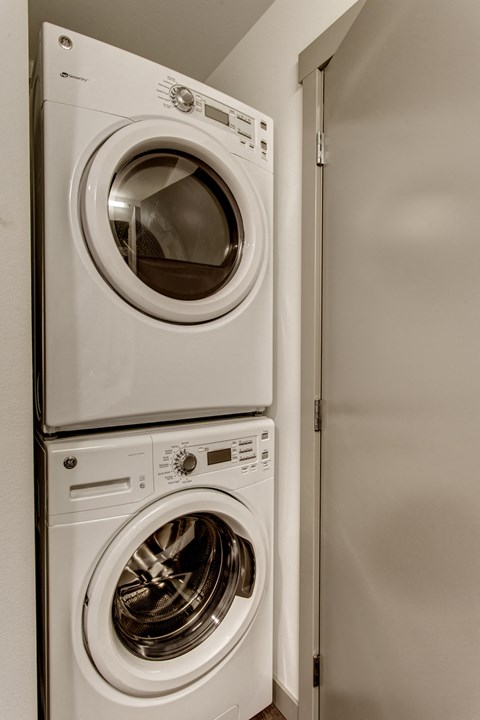 a front loading washer and dryer in a home laundry room