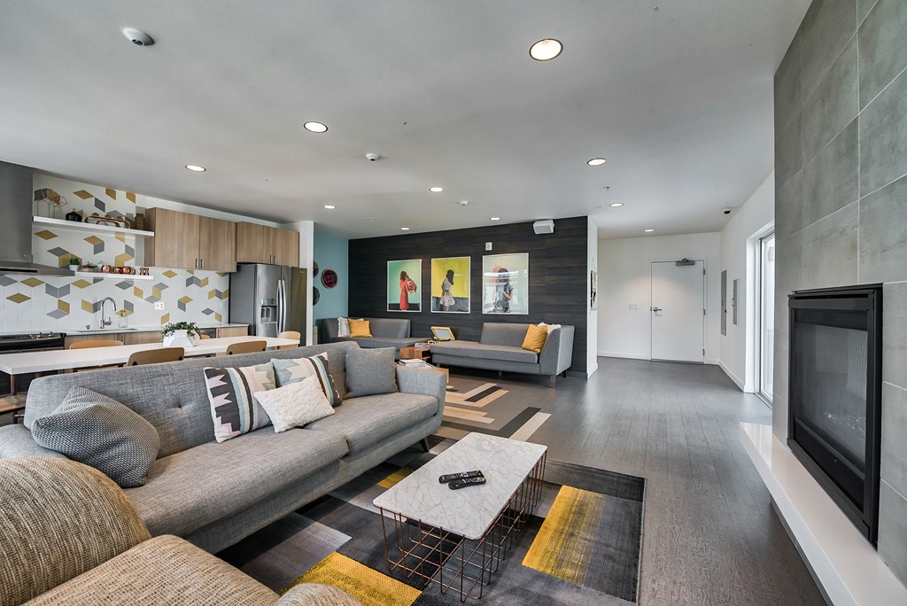 A modern living room with a grey sofa and a coffee table.
