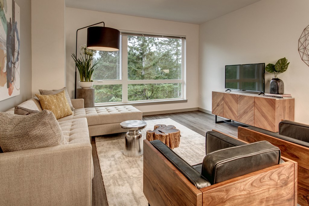 a living room with a couch and a chair and a television
