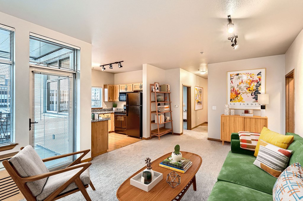 a living room with a green couch and a table