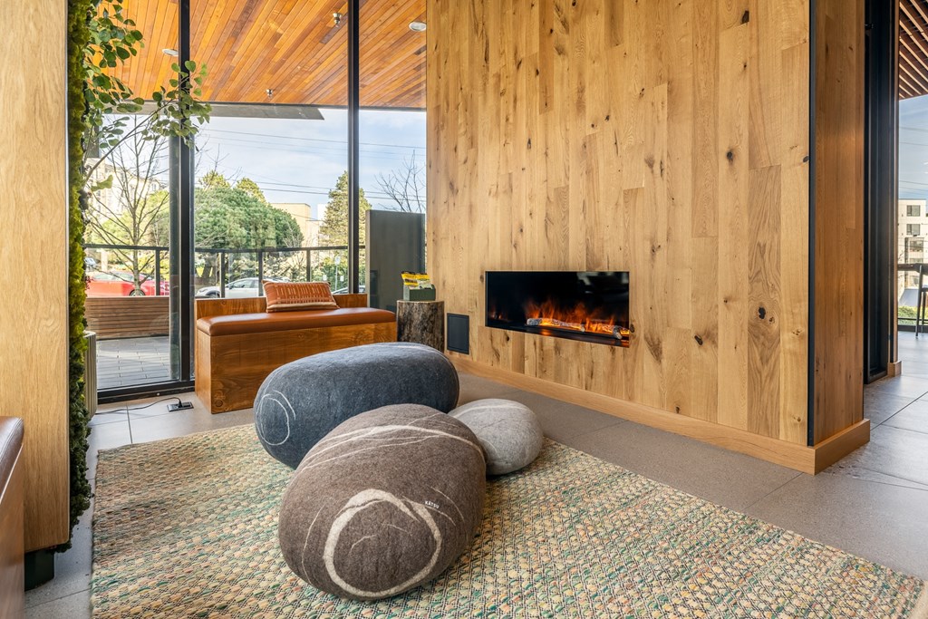 A living room with a fireplace and a large window.
