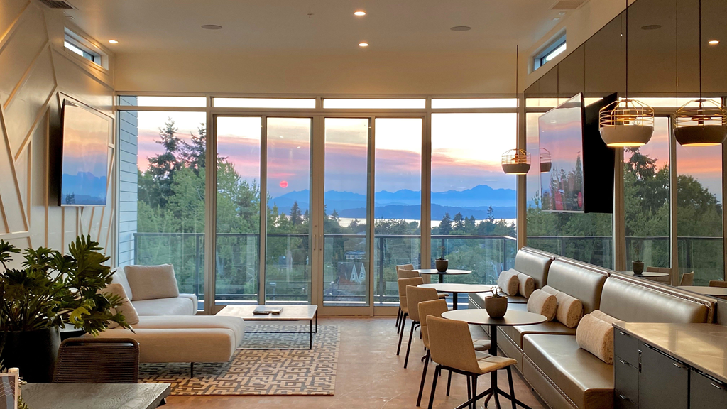 a living room with large windows and a view of the mountains