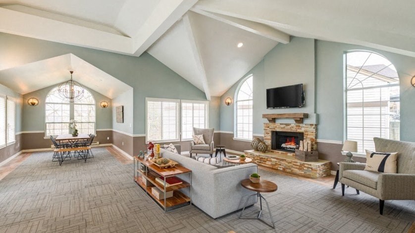 a large living room with a fireplace and a large window