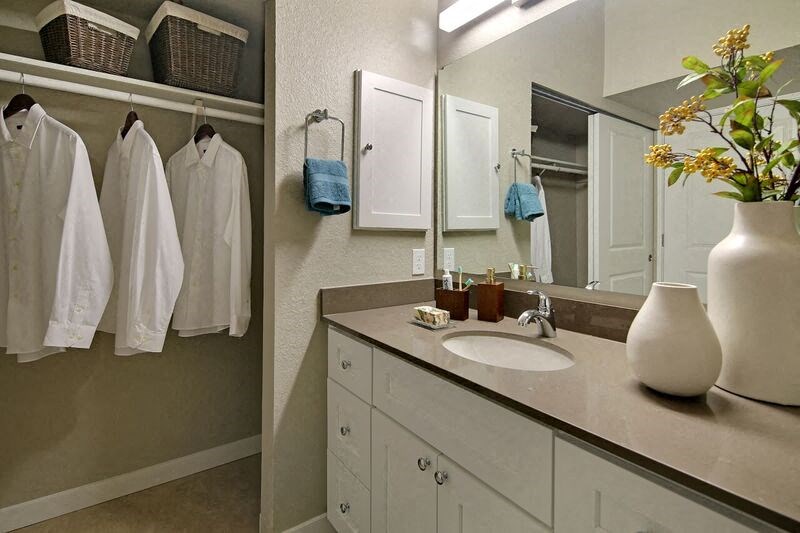 a bathroom with a white sink and a mirror