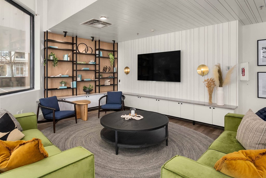 a living room filled with furniture and a flat screen tv