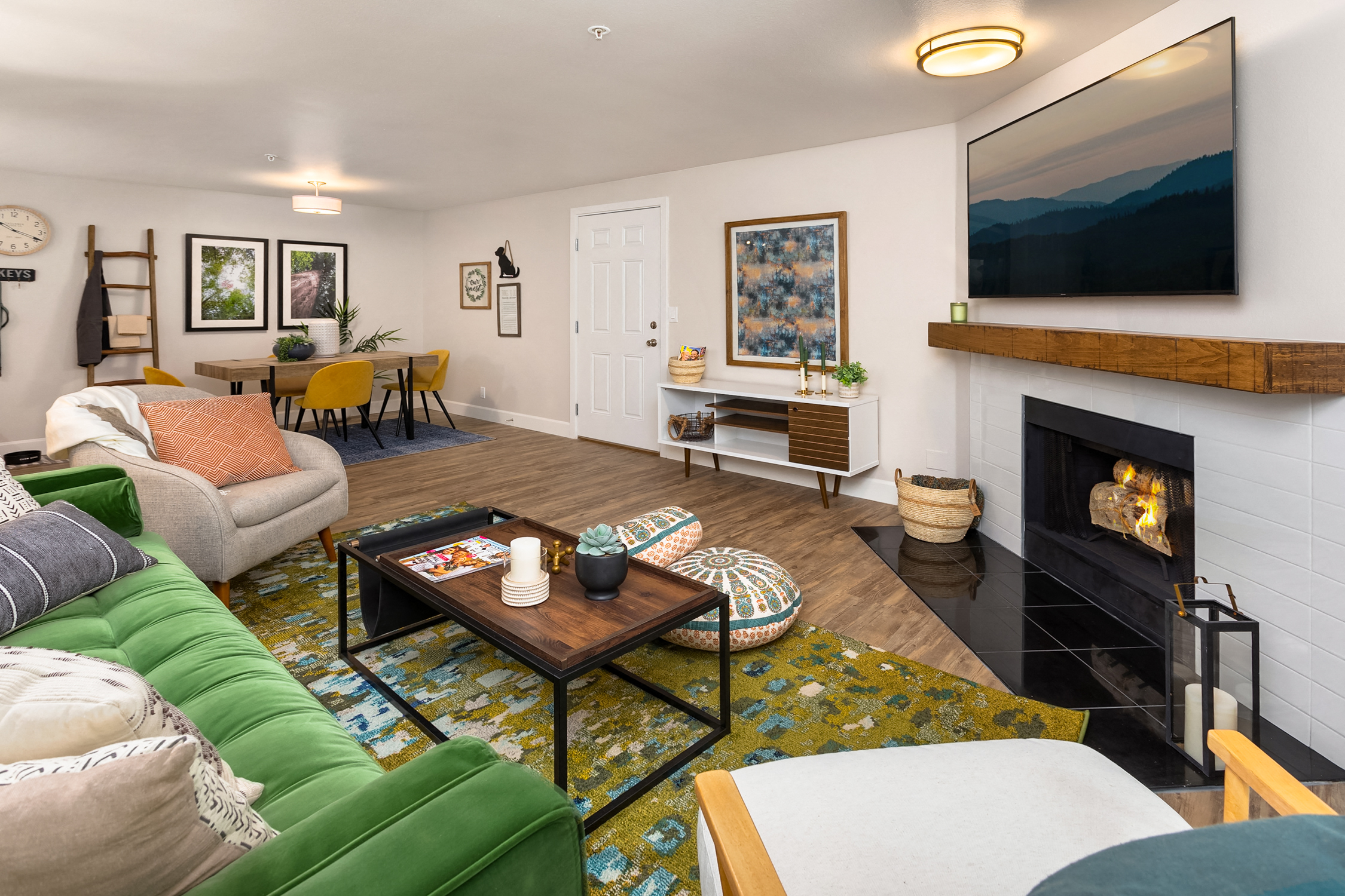 a living room with a fireplace and a green couch