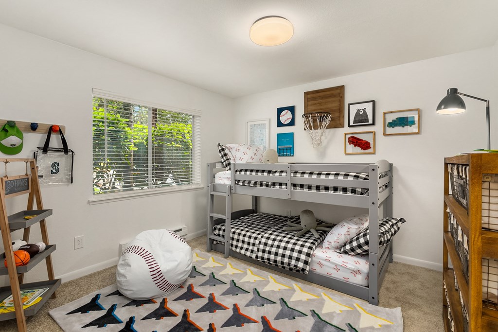 a childrens bedroom with bunk beds and a baseball rug