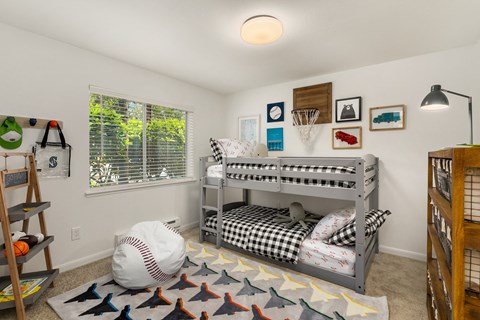 a childrens bedroom with bunk beds and a baseball rug