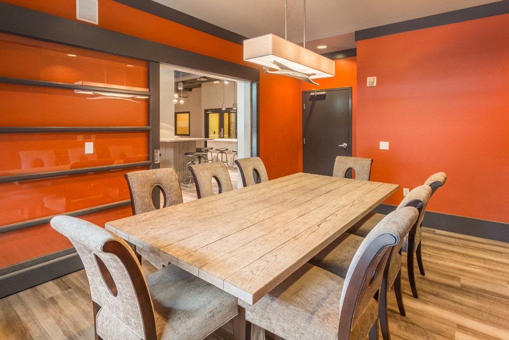 a dining room with a wooden table and chairs