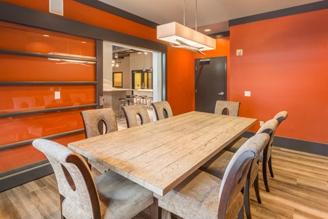 a dining room with a wooden table and chairs