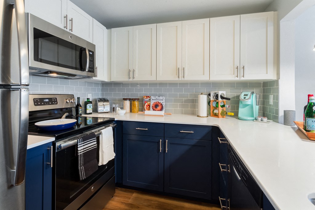 Modern kitchen cabinets and stainless appliances.
