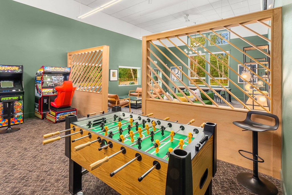 a game room with a foosball table and other games