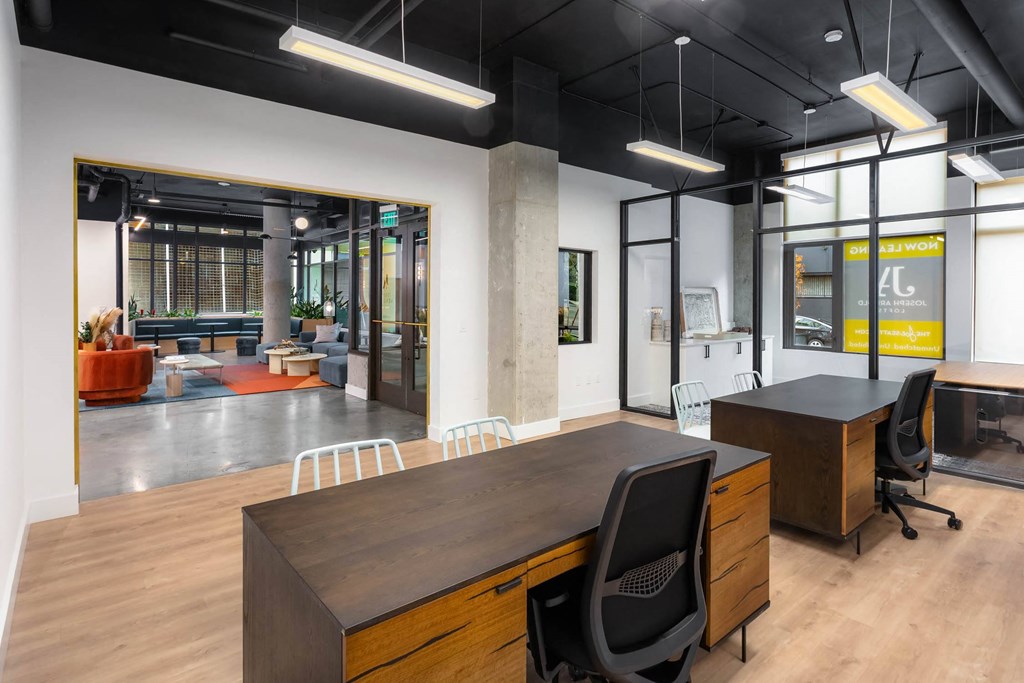 a conference room with a large desk and chairs in a office