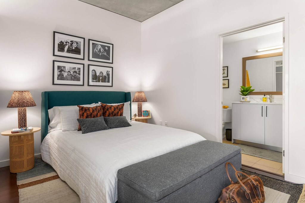 a bedroom with a large bed and a mirror