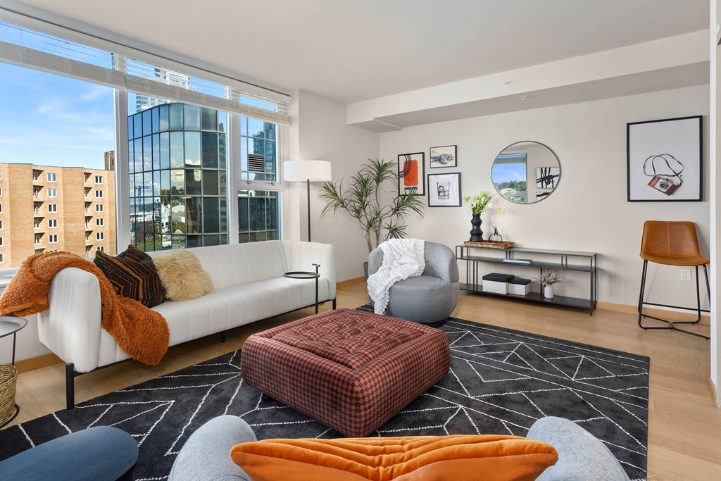 a living room with a white couch and a large window