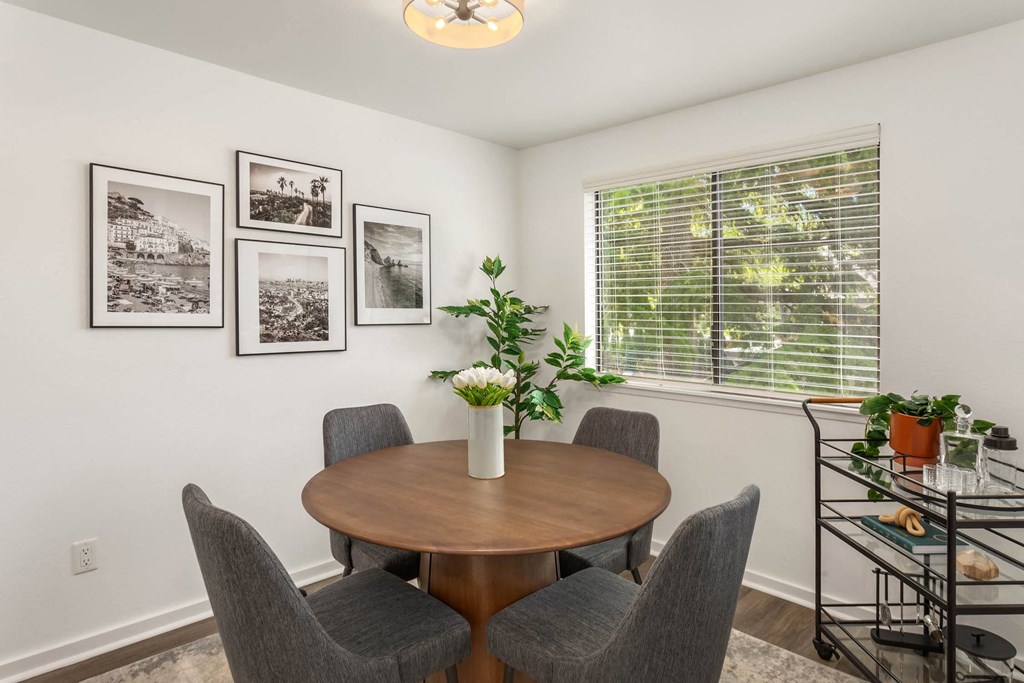 a dining room with a table and four chairs