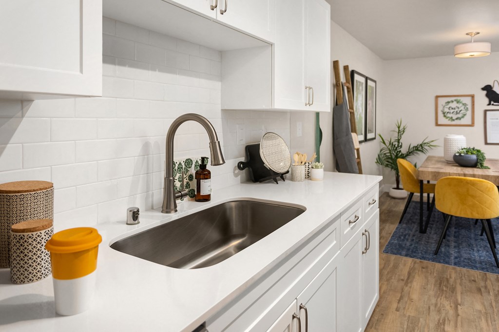 a kitchen with white cabinets and a sink