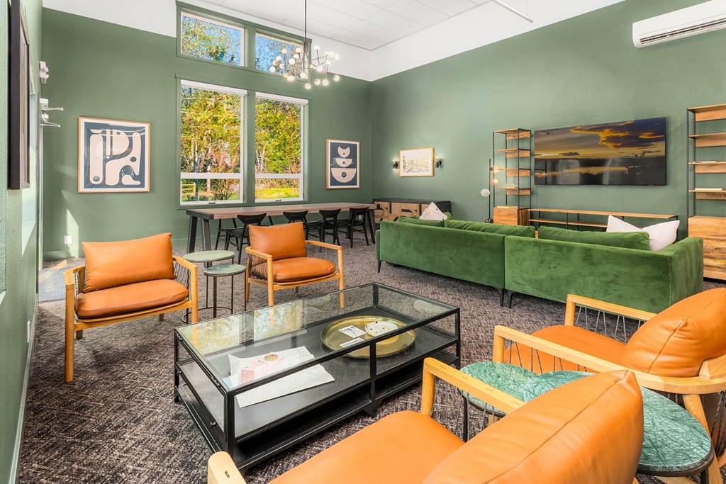 a living room with green walls and orange and green furniture