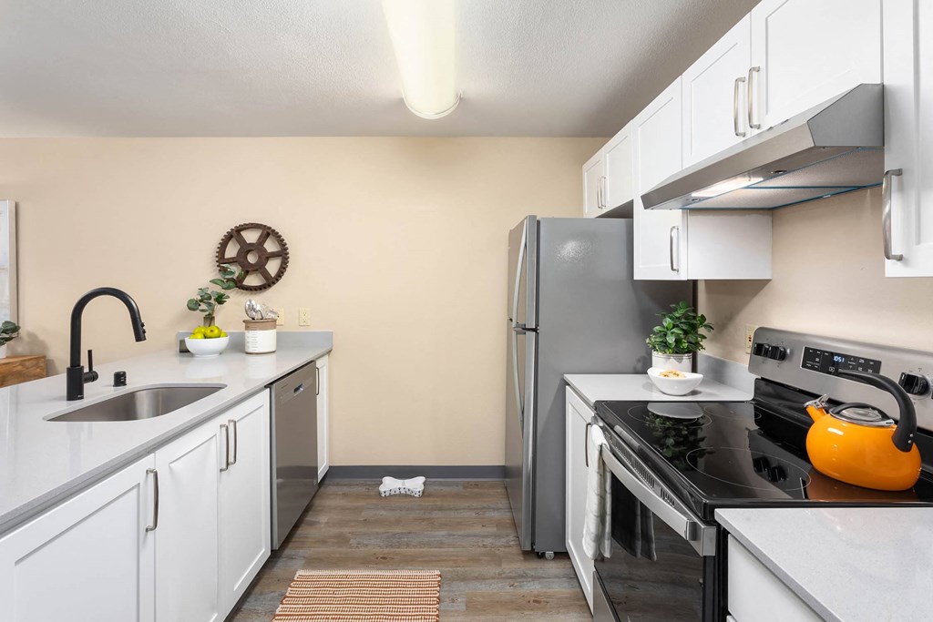 a kitchen with stainless steel appliances and white cabinets