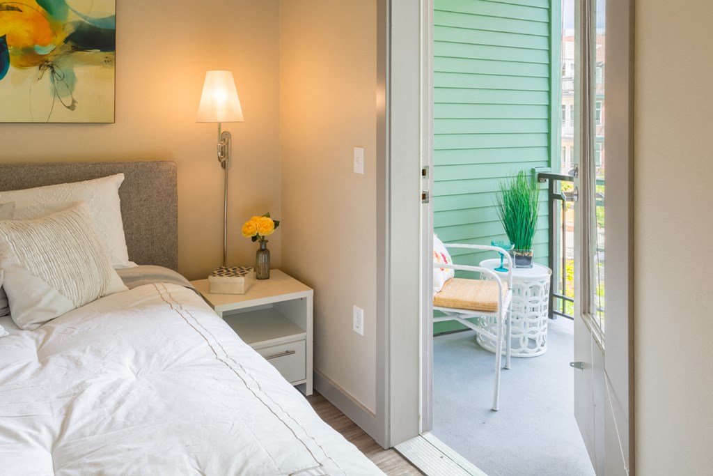 a bedroom with a bed and a door to a patio