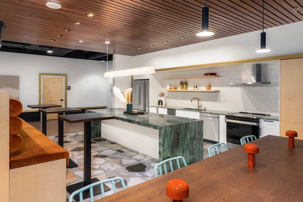 a large kitchen with a wooden table and a counter top