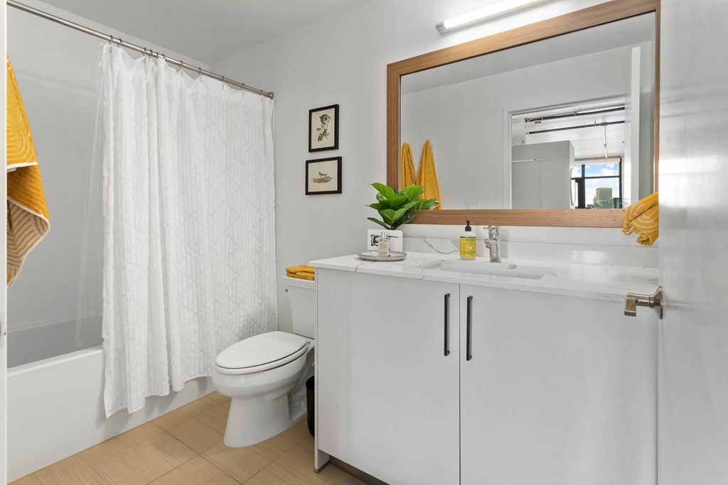 a bathroom with a sink and a toilet and a shower