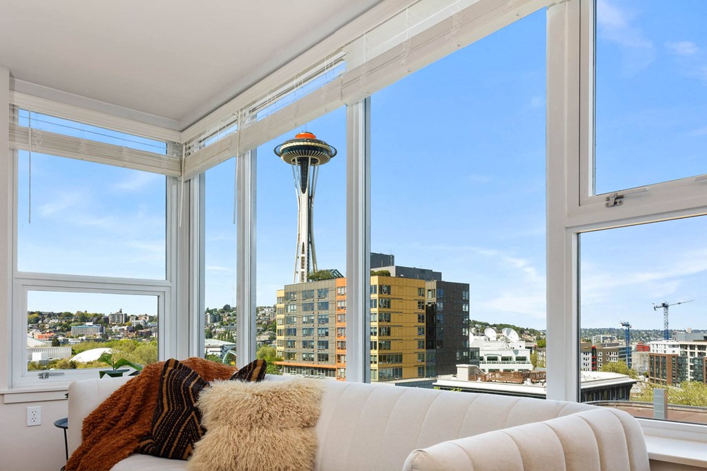 the view of the space needle from the living room of an apartment