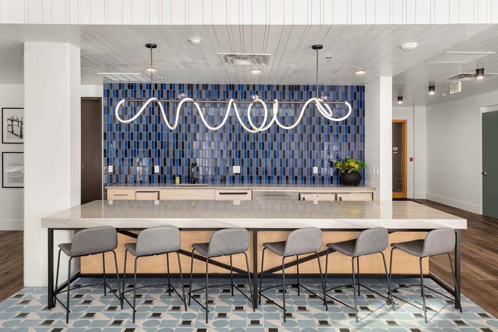 a kitchen with a large island and a long table with chairs in front of it