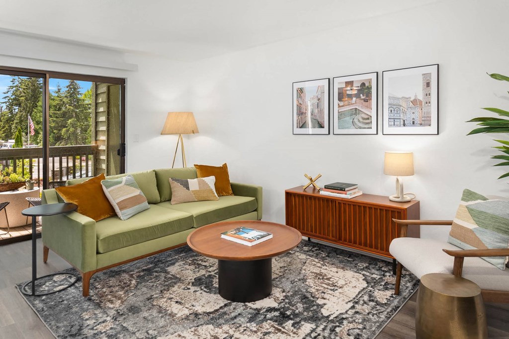 a living room with a green couch and a coffee table