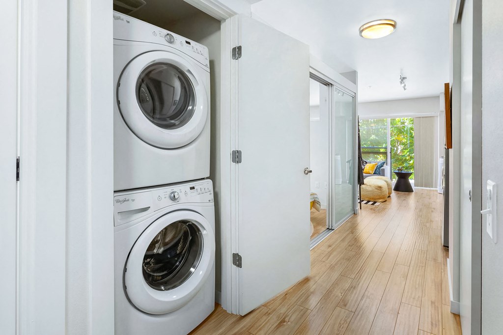 a white laundry room with a washing machine and a dryer