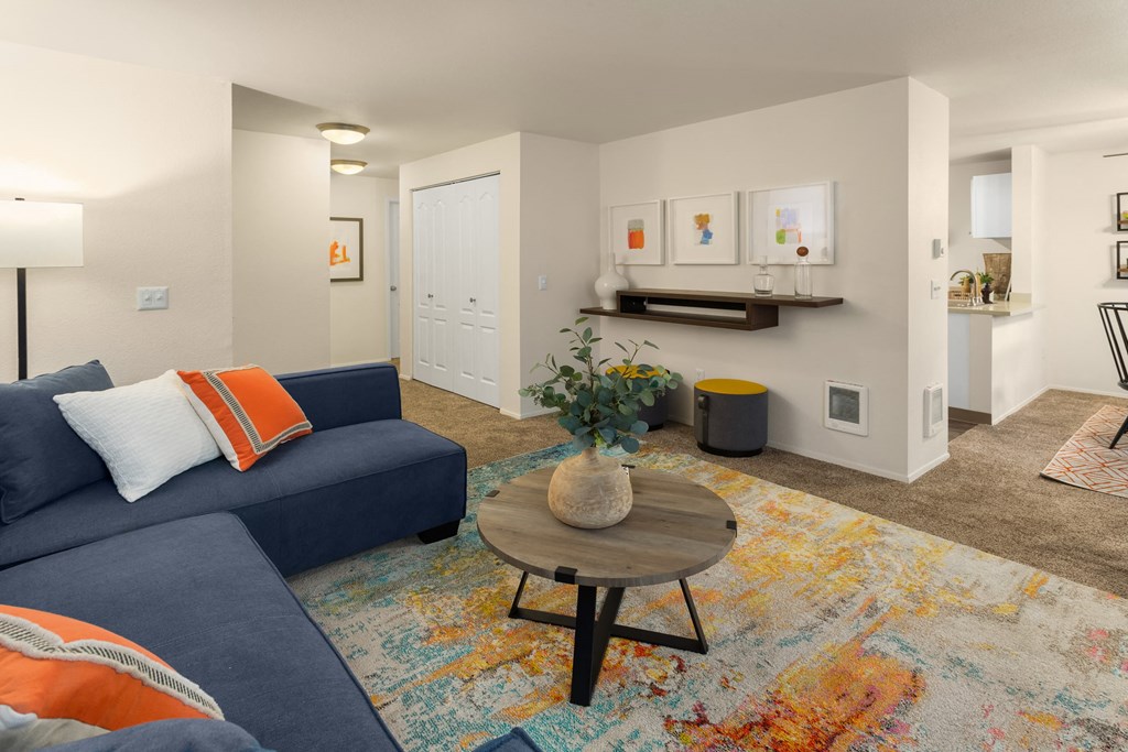 a living room with a blue couch and a coffee table