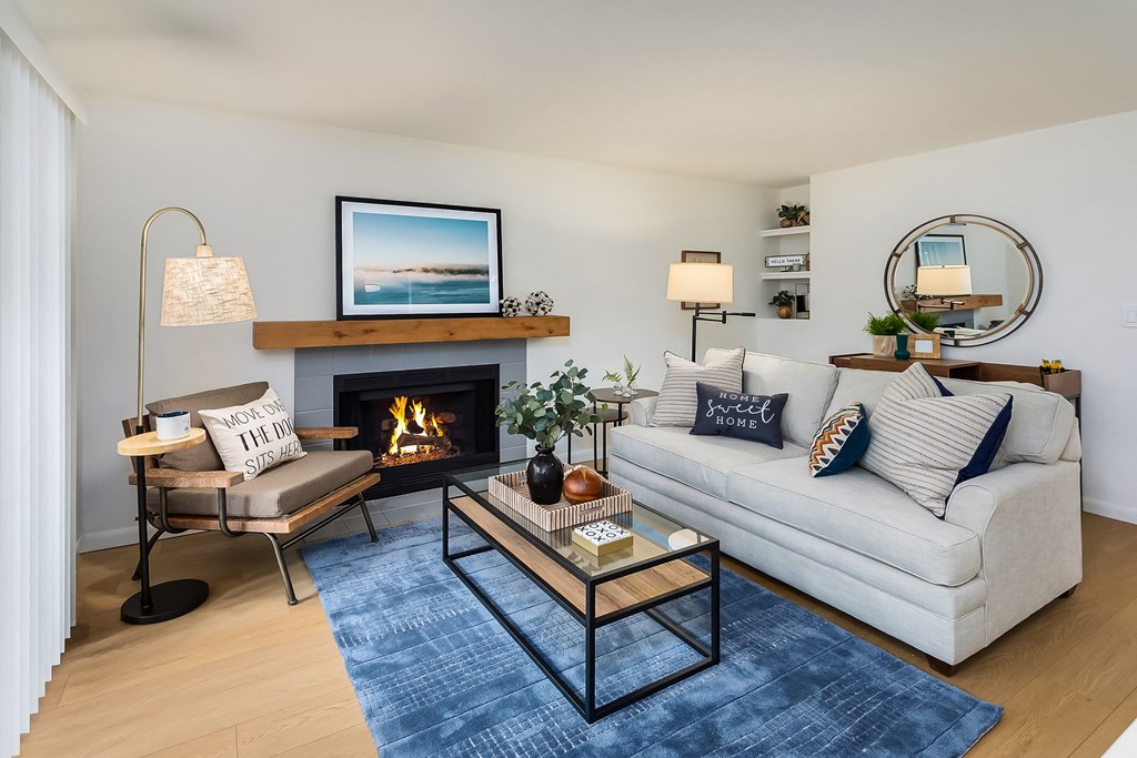 a living room with a couch and a coffee table and a fireplace