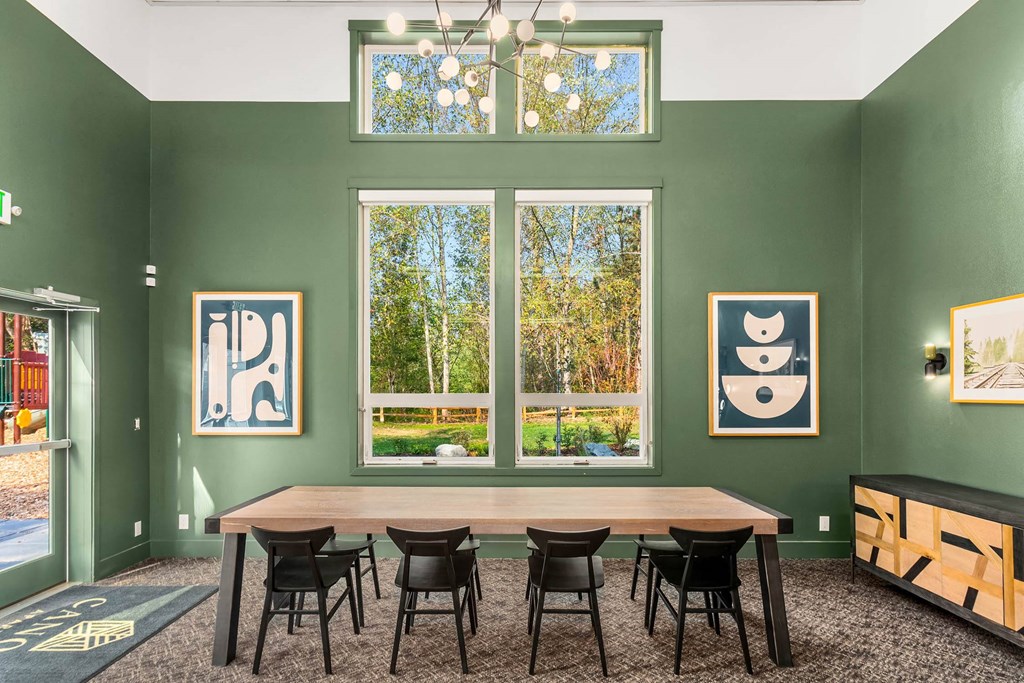 a dining room with a table and chairs and a window
