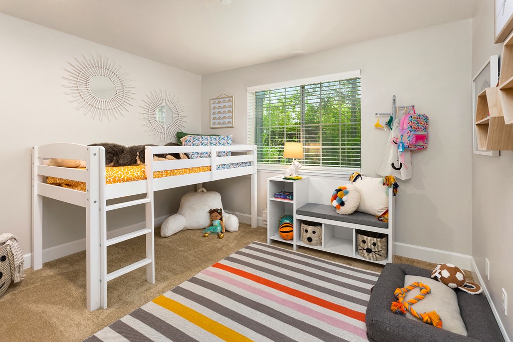 a kids bedroom with bunk beds and a window