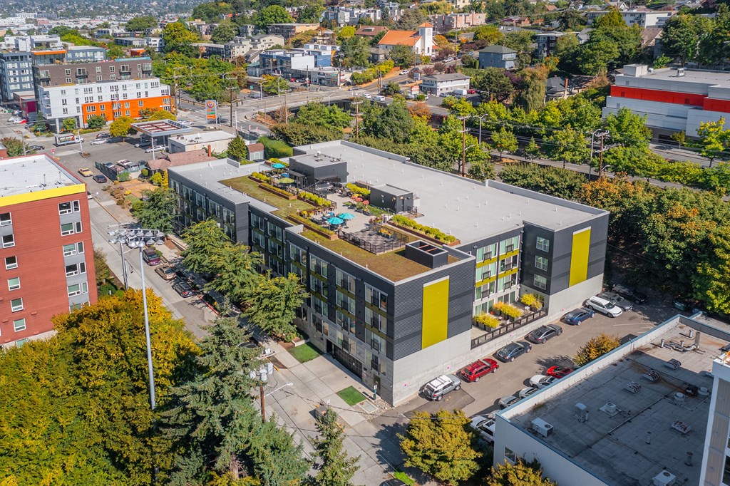 an aerial view of an apartment building with a yellow and black facade