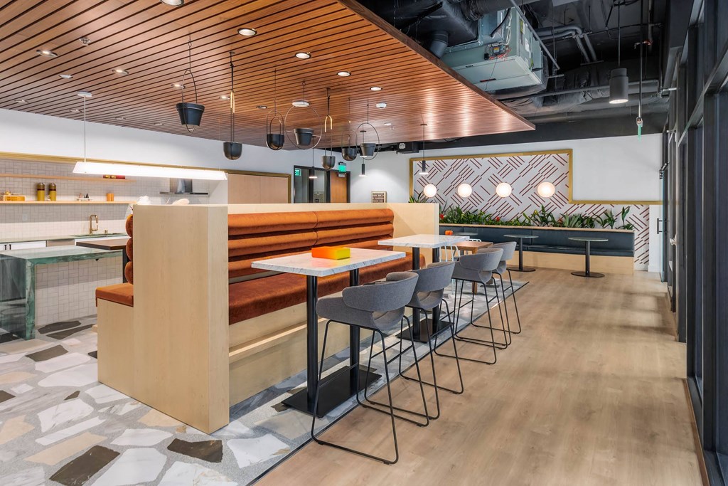a dining area with tables and chairs and a long wooden divider