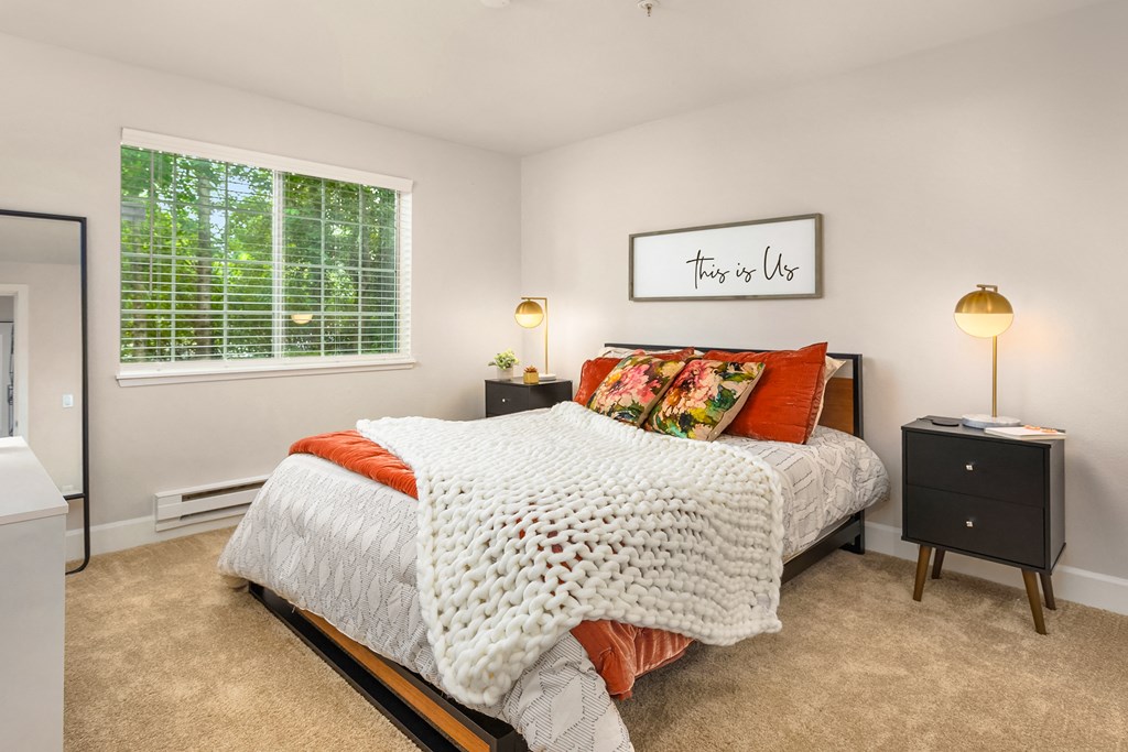 a bedroom with a bed and a window