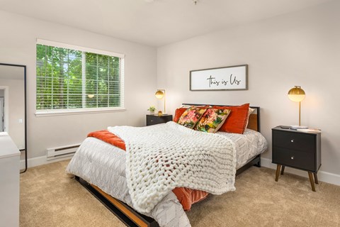 a bedroom with a bed and a window