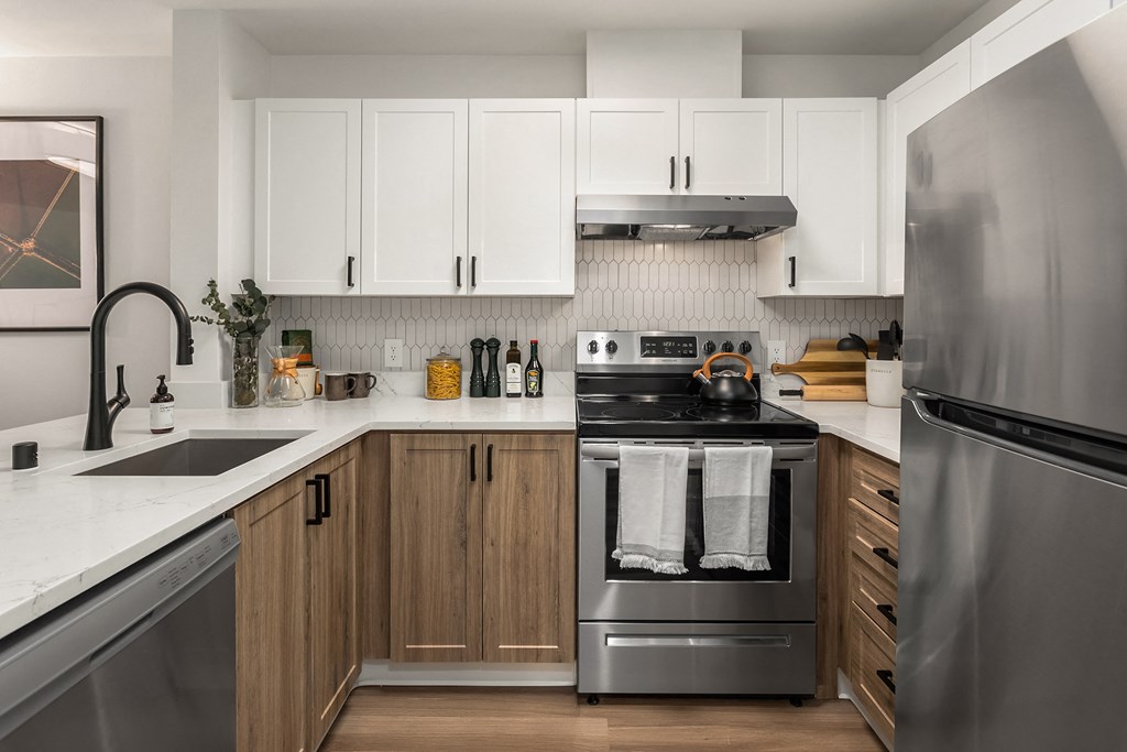 a kitchen with stainless steel appliances and white cabinets
