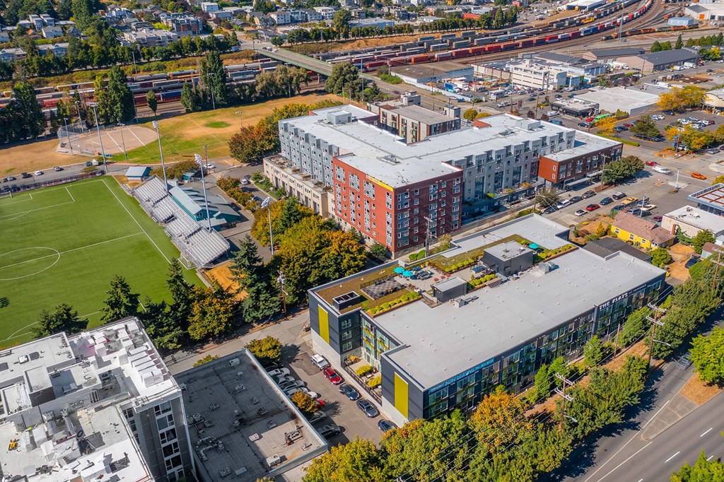 an aerial view of a campus with buildings and a field