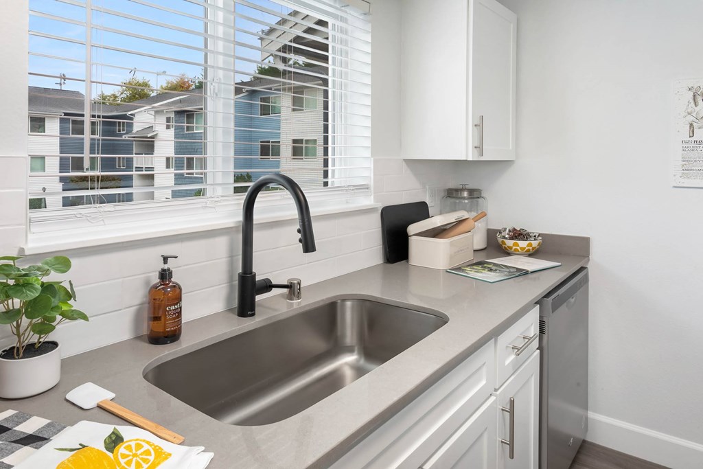 A kitchen with a sink and a window.