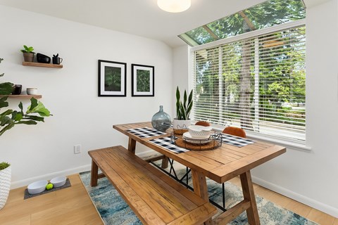 a dining room with a wooden table and a large window