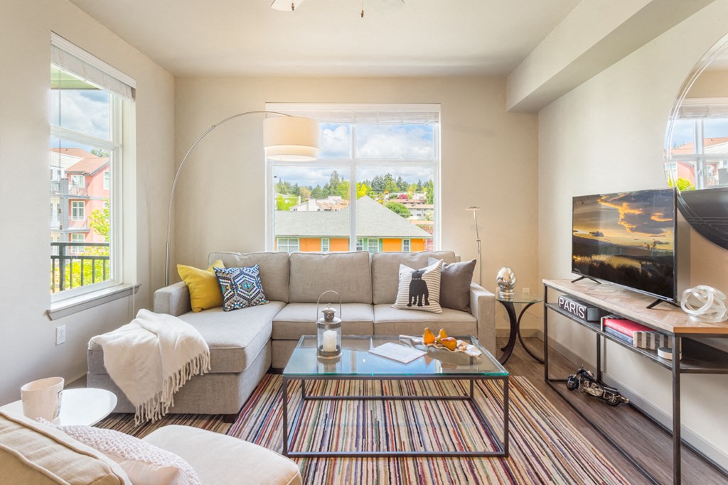 a living room with a couch and a coffee table and a television